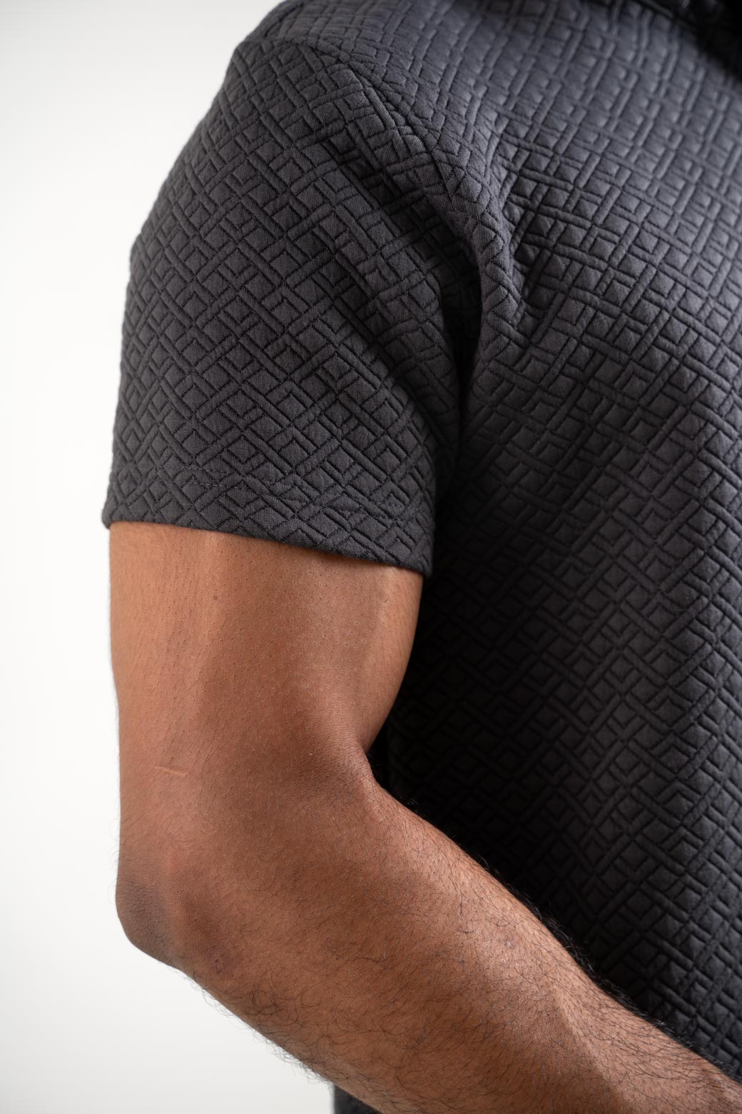 Detailed close-up of the grey polo t-shirt's stitching, showcasing its high-quality construction